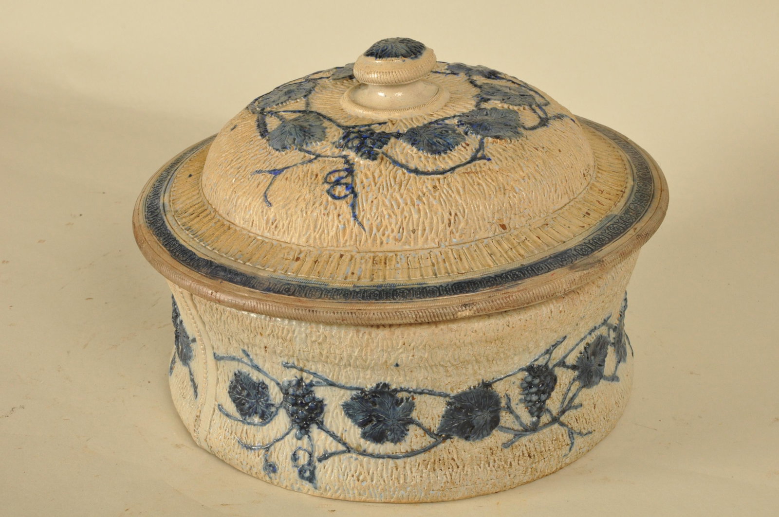 Blue Decorated Stoneware Covered Casserole: Salt glazed cobalt grape and leaf pattern dec. 8.5 in H x 14 in. dia.