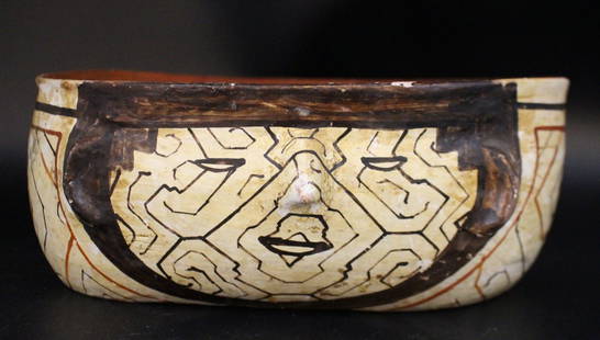 SHIPIBO PERUVIAN POTTERY CIRCA 1900: A hand painted pottery vase by the Shipibo people of Peru, circa 1900, in earthenware with hand painted geometric designs, using natural pigments, which represent constellations and various planets...