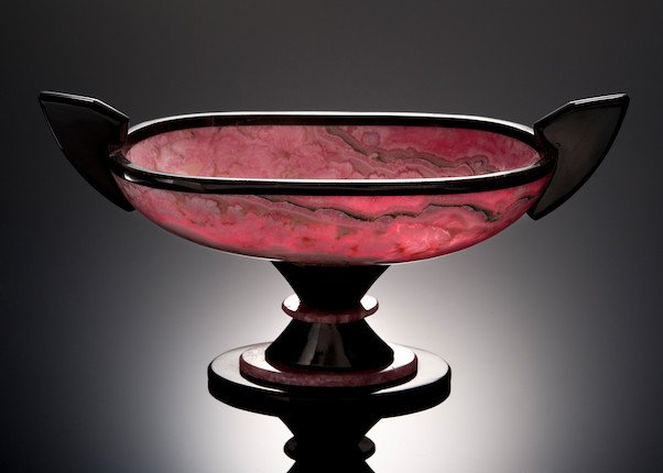 RHODOCHROSITE AND BLACK ONYX PRESENTATION BOWL: Rhodochrosite and Black Onyx Presentation Bowl. Carved of Argentinian rhodochrosite displaying excellent banding and translucency, raised on a black onyx and rhodochrosite base, with a black onyx bord
