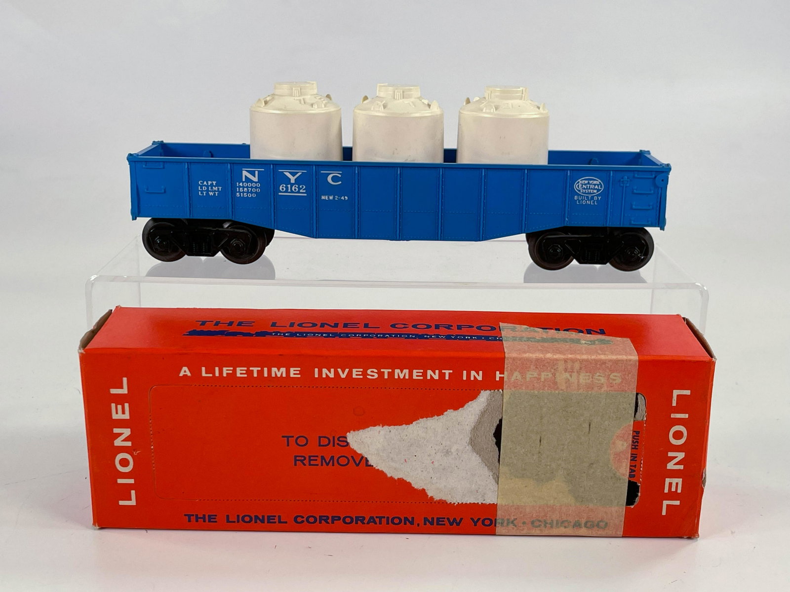 Lionel #6162-1 Blue Gondola Car with Three Canisters: Lionel #6162-1 Blue Gondola Car with Three Canisters and Original Punch Box, with #6162-1 Blue Gondola Car in C7 plus and original punch box showing wear and tape (see photos).