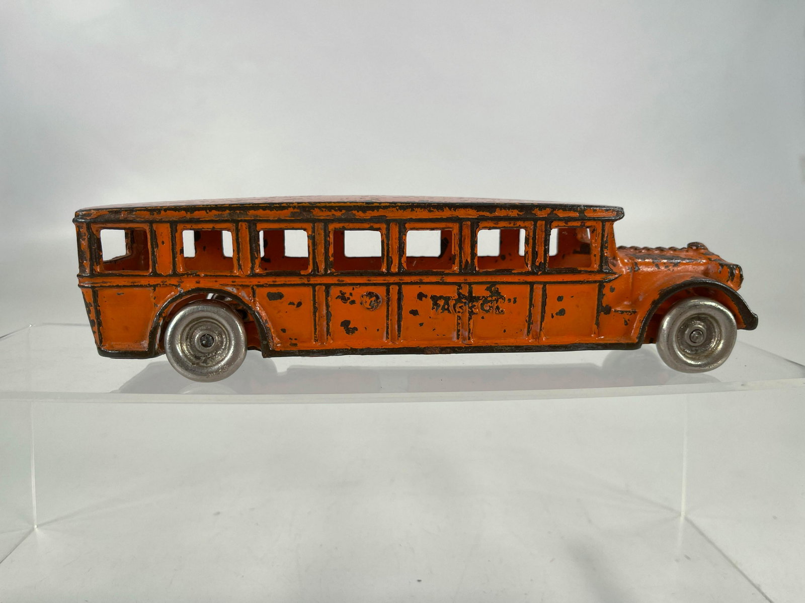 Arcade toy orange bus: Arcade toy orange bus, in C5.
