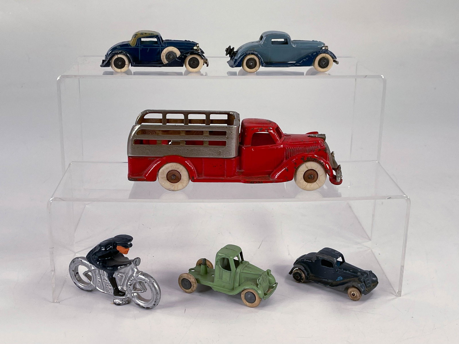 Tootsietoy x4, Barclay cop on silver motorcycle and: Tootsietoy x4, Barclay cop on silver motorcycle and Arcade red Pontiac stake truck, in all over C7.
