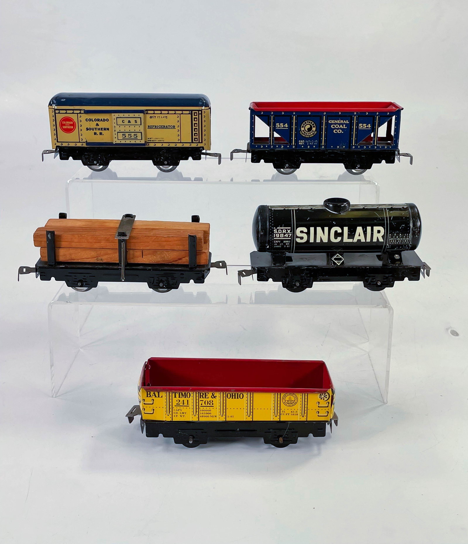 MARX yellow litho Gondola, Sinclair tank car, #554 coal: MARX yellow litho Gondola, Sinclair tank car, #554 coal car, American Flyer lumber car and MARX Colorado and southern refrigerator car, with all lot items in overall C7 condition.