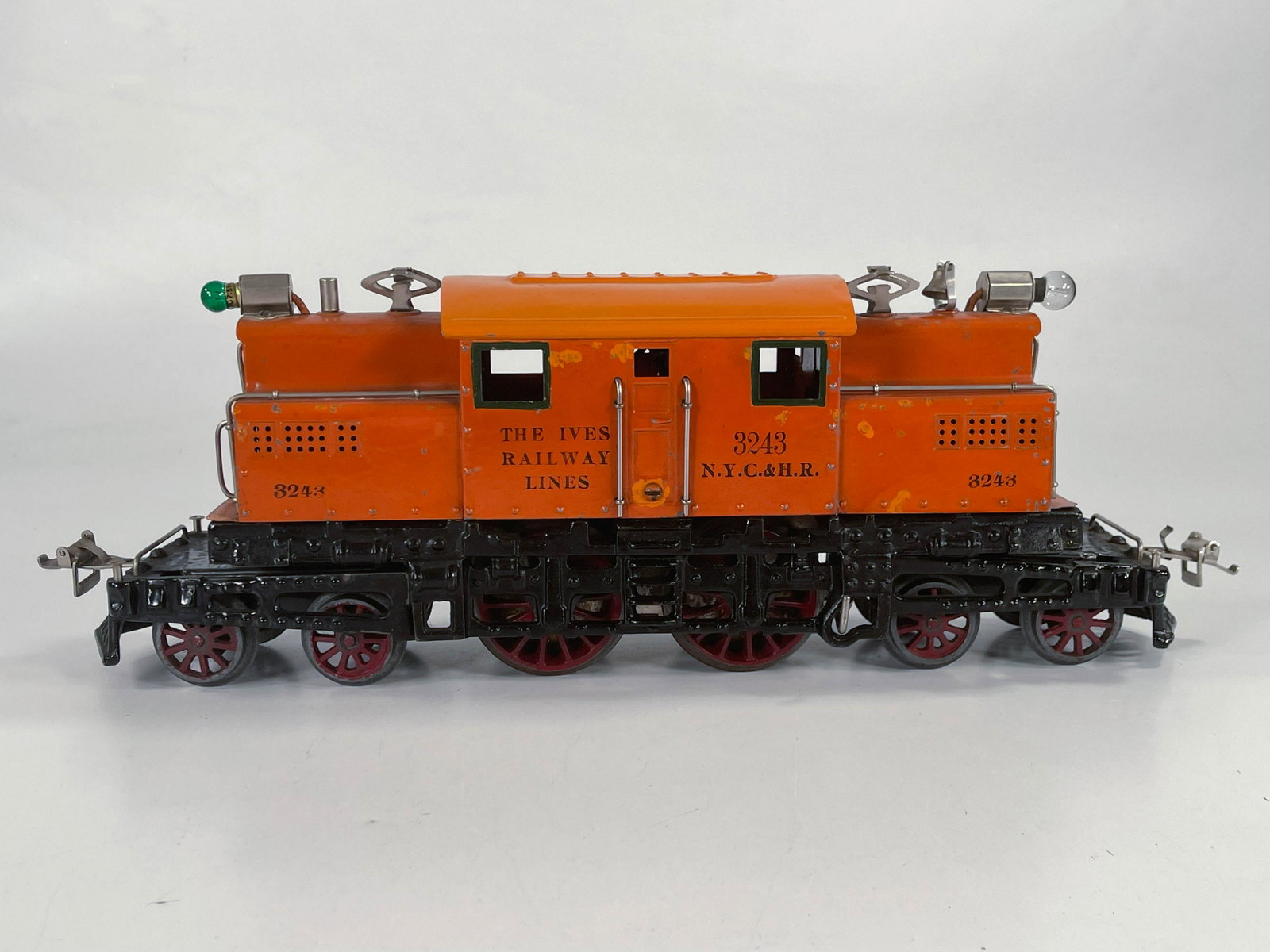 Ives Prewar #3243 orange electric locomotive: Ives Prewar #3243 orange electric locomotive, in C6 minus given the locomotive having a repainted roof and a touch up on the side.