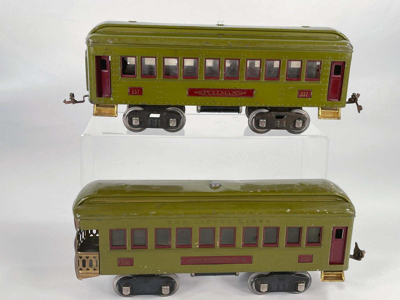 Lionel Prewar #337 and #338 olive green passenger cars: Lionel Prewar #337 and #338 olive green passenger cars, with the #337 in C6 plus and the #338 in C6 minus given the roof dent in the front of the car.
