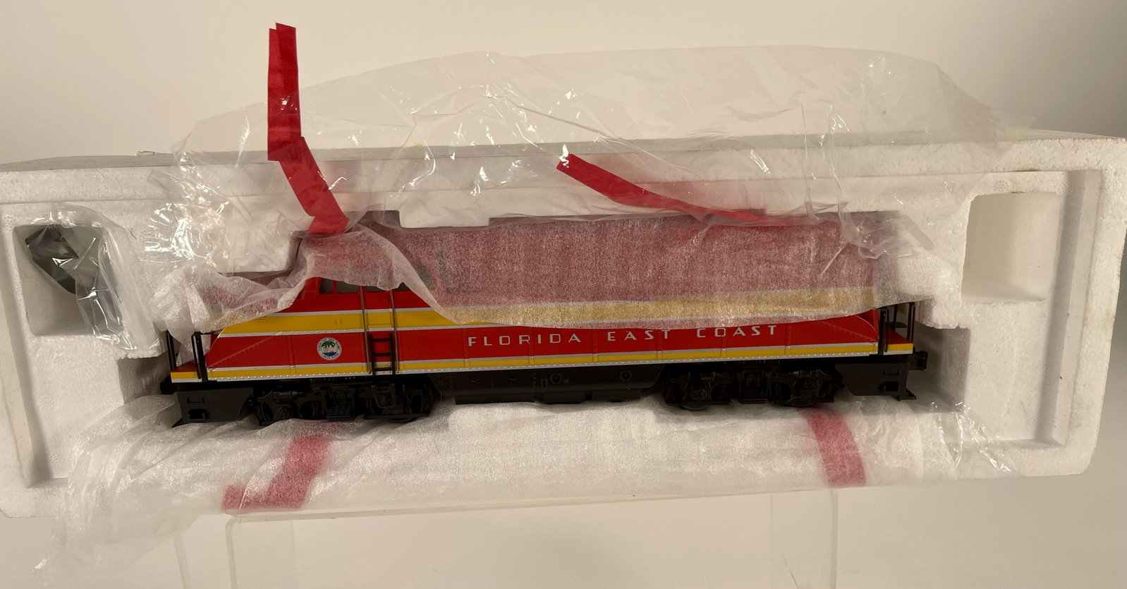 MTH O Gauge Florida East Coast Diesel, in Original: MTH O Gauge Florida East Coast Diesel, in Original Styrofoam Packing, in C10 factory new. Missing original box.