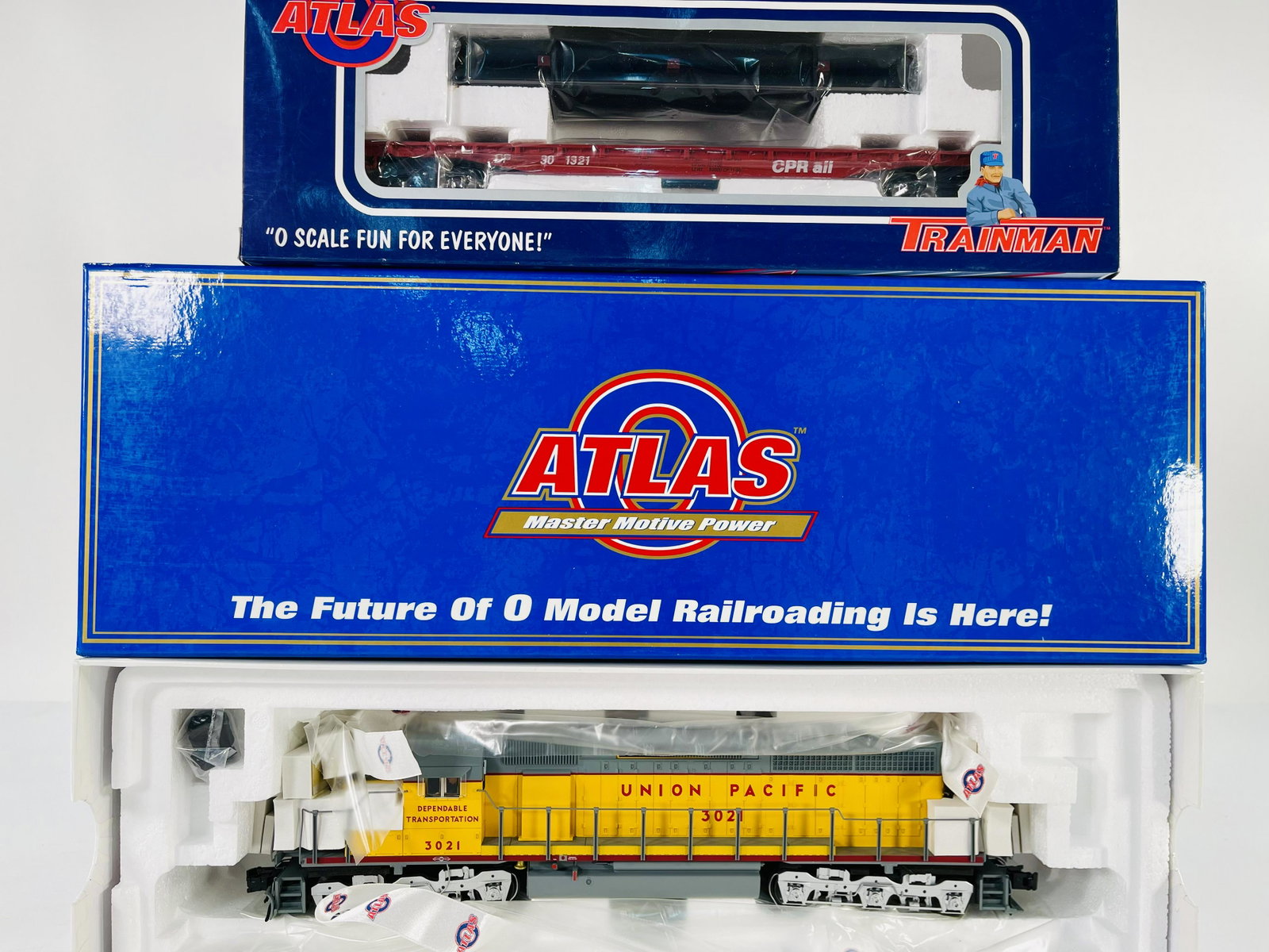 Atlas O Gauge Union Pacific SD 40 Locomotive Unpowered and Canadian Pacific Rail Flat Car with Pipe: Atlas O Gauge Union Pacific SD 40 Locomotive Unpowered and Canadian Pacific Rail Flat Car with Pipe Load, all in original boxes and in C10 factory new condition.