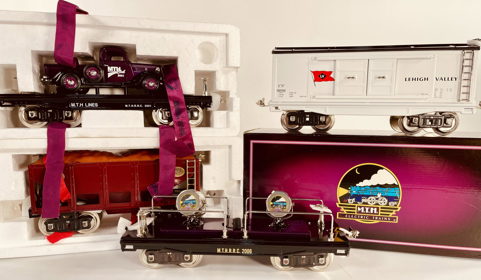 MTH Tinplate Traditions Standard Gauge 200 Series Searchlight Car, 221 ore car, 200 series flat car: MTH Tinplate Traditions Standard Gauge 200 Series Searchlight Car, 221 ore car, 200 series flat car with purple pickup truck and 200 series box car Lehigh Valley with nickel, all in original boxes and