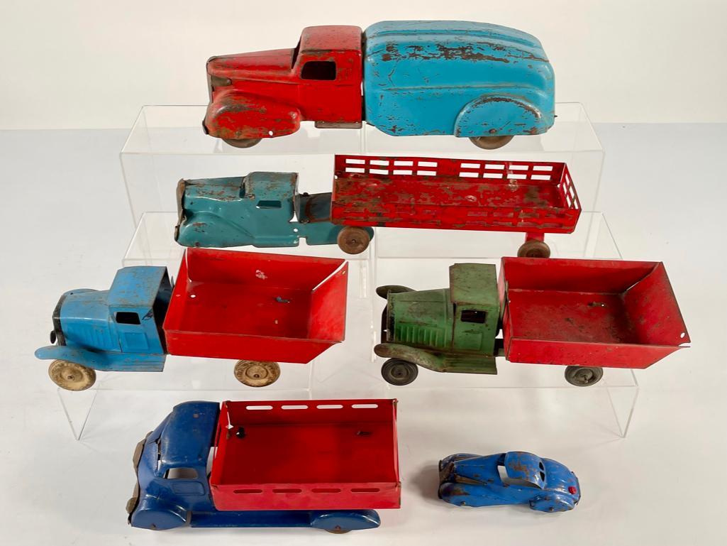Wyandotte Truck X3 and Marx Transport car and Marx Transport Truck with Trailer and Car: Wyandotte Truck X3 and Marx Transport car and Marx Transport Truck with Trailer and Car, all with generally fair to moderate playwear.