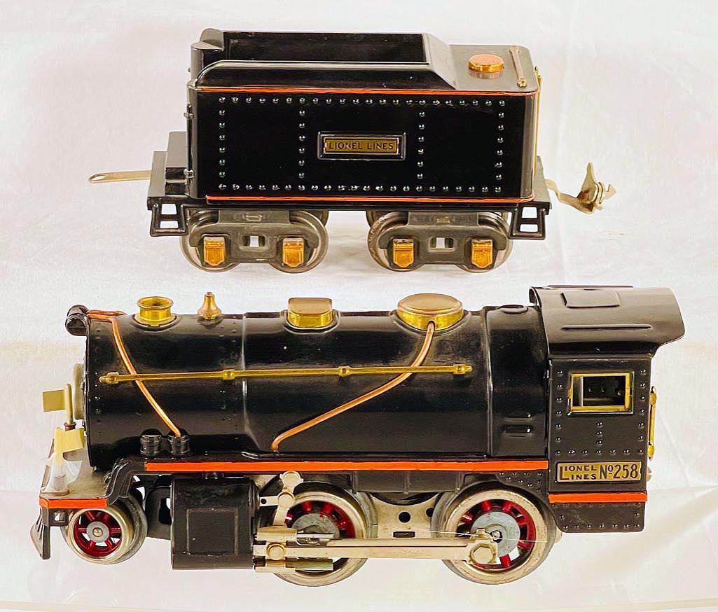 Lionel Prewar O Gauge 258 Black/Orange Stripe Loco with 257T Black/Orange Stripe Tender: Lionel Prewar O Gauge 258 Black/Orange Stripe Loco with 257T Black/Orange Stripe Tender, in C7 overall for both pieces. The Tender is missing its metal black coal cover.