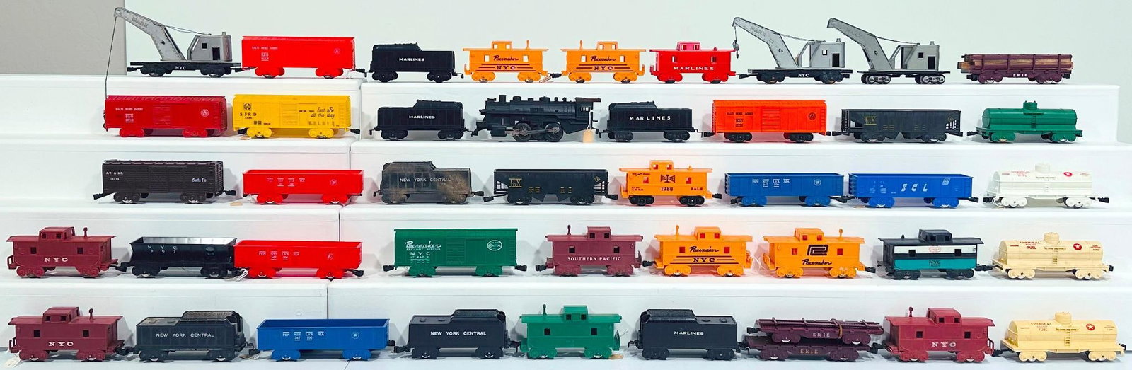 Marx Postwar O Gauge Assorted Plastic Freight Cars - Assorted Plastic Tenders and one Plastic Loco: Marx Postwar O Gauge Assorted Plastic Freight Cars - Assorted Plastic Tenders and one Plastic 0 - 4 - 0 Locomotive, each in C6 to C7. Due to the size and volume of this Lot, it will be costly to
