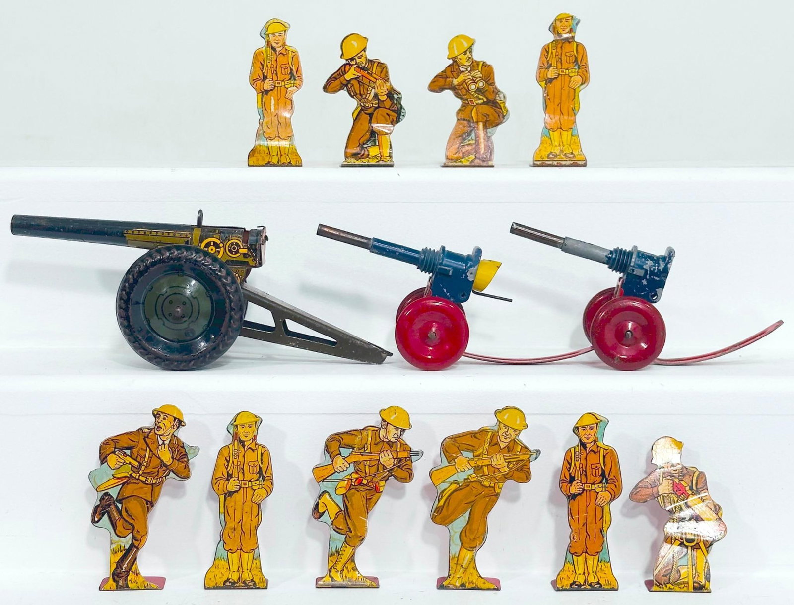 Marx Postwar Toy Cannon X3 and Ten (10) Cardboard Military Figures: Marx Postwar Toy Cannon X3 and Ten (10) Cardboard Military Figures, in C6 to C7 for each cannon and C7 for the cardboard military figures.