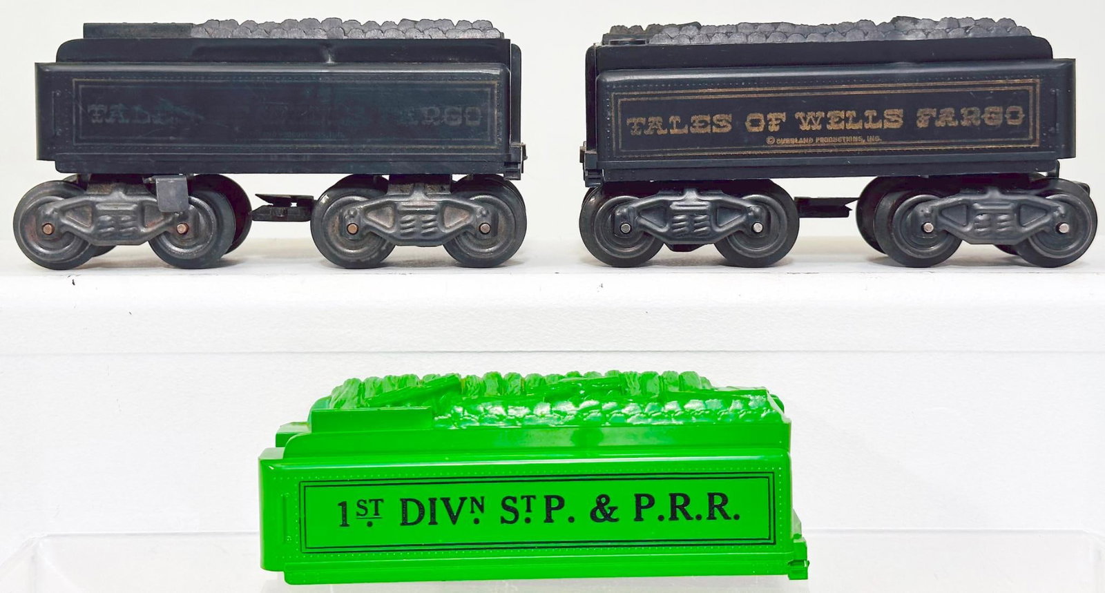 Marx Postwar O Gauge Three (3) Assorted Tenders Factory Archives: Marx Postwar O Gauge Three (3) Assorted Tenders Factory Archives, with one green Tender shell only, in C7, another Tender in C6 plus with rust on the wheels and another Tender, with Factory Archive ma
