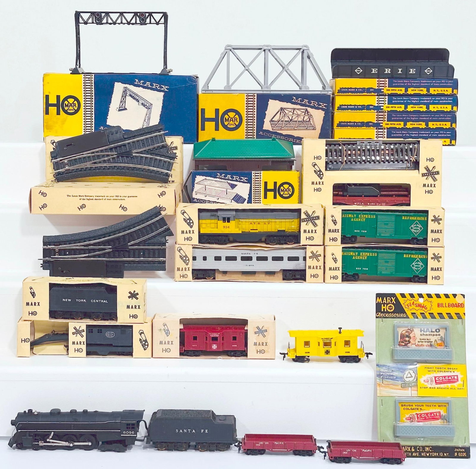 Marx Postwar HO Scale Assorted Engines and Passenger Cars/Freight Cars/UP Flat Car X2 Factory Protos: Marx Postwar HO Scale Assorted Engines and Passenger Cars and Freight Cars, each in C8 or better and each with its original box. This Lot also includes a Santa Fe Hudson Locomotive and Tender, each in