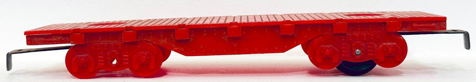 Marx Postwar O Gauge 4 Wheel Red Plastic Flat Car Factory Prototype: Marx Postwar O Gauge 4 Wheel Red Plastic Flat Car Factory Prototype, Factory Prototype Model #1879, in C6 and missing one wheel set.