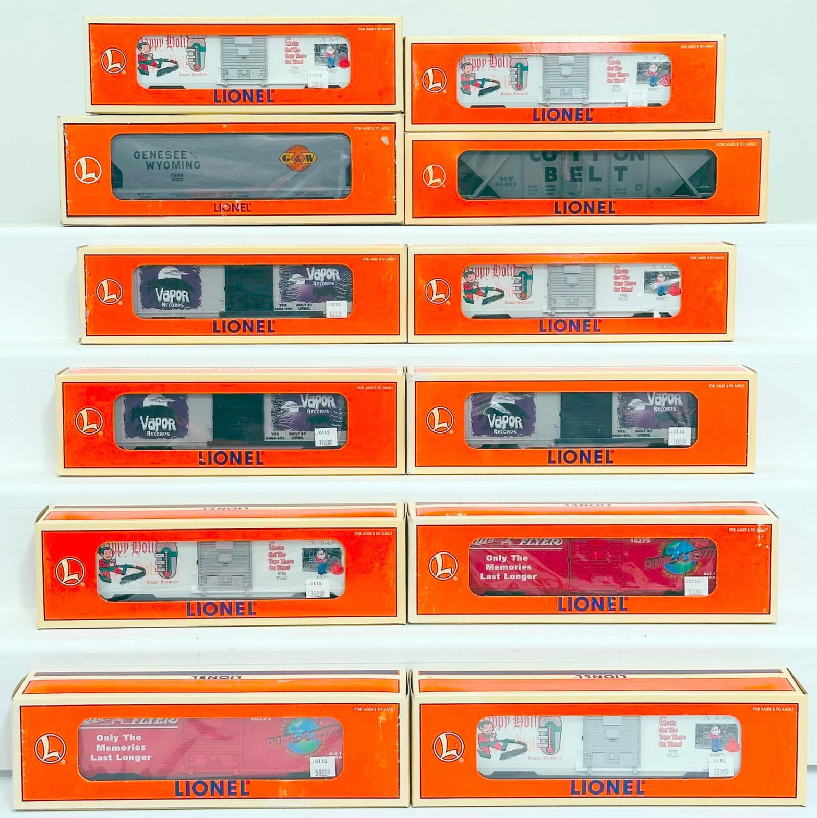 Lionel Modern O Gauge Twelve (12) Assorted Freight Cars Boxed: Lionel Modern O Gauge Twelve (12) Assorted Freight Cars Boxed, including 1997 Christmas Box Car X5, Cotton Belt Coal Hopper, 34600 Radio Flyer Box Car X2, 6464 Vapor Box Car X3 and Genesse Wyoming 3