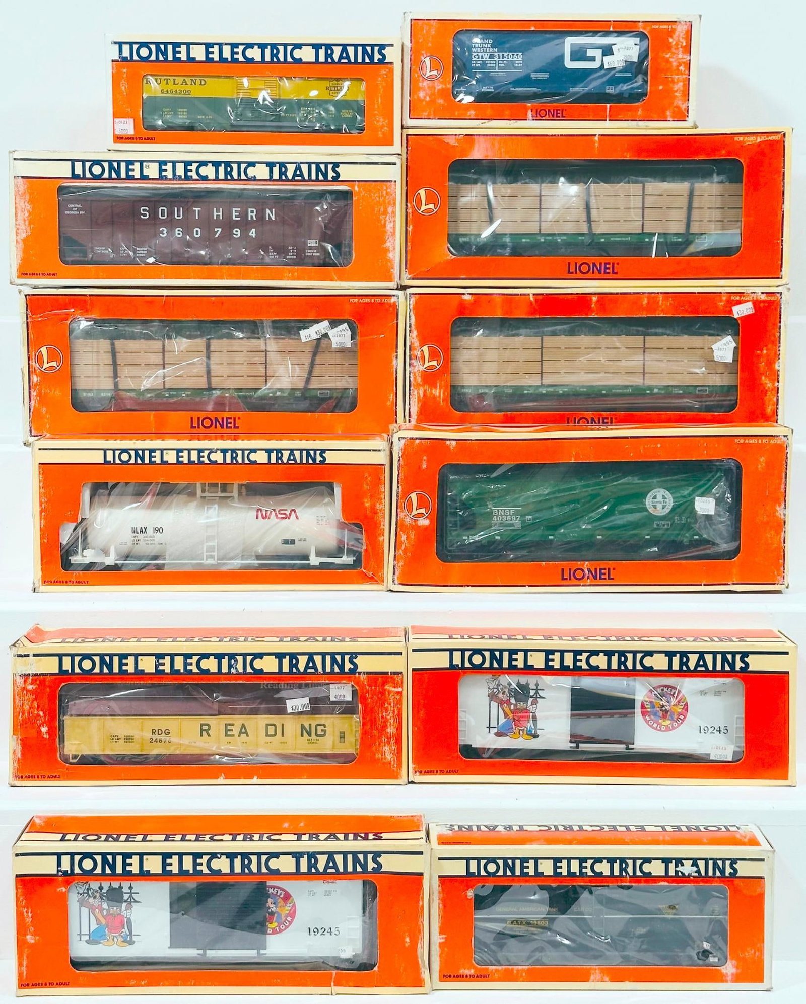 Lionel Modern O Gauge Twelve (12) Assorted Freight Cars Boxed: Lionel Modern O Gauge Twelve (12) Assorted Freight Cars Boxed, including LOTS 96 GT 2 Bay ACF Hopper, Reading Gondola with coil covers, Mickey's World Tour Hi Cube, FC - 1 - Beam Burlington Northern X