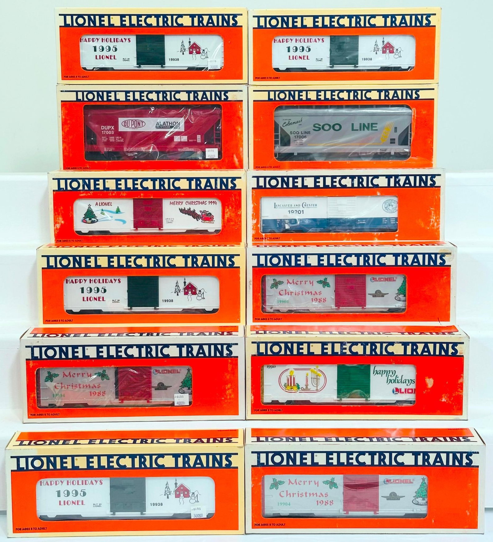 Lionel Modern O Gauge Twelve (12) Assorted Freight Cars Boxed: Lionel Modern O Gauge Twelve (12) Assorted Freight Cars Boxed, including 1990 O Gauge Seasons Greetings Car, 1988 Lionel Christmas Car, O Gauge Christmas Box Car, Lionel Christmas Box Car 1995, DuPont