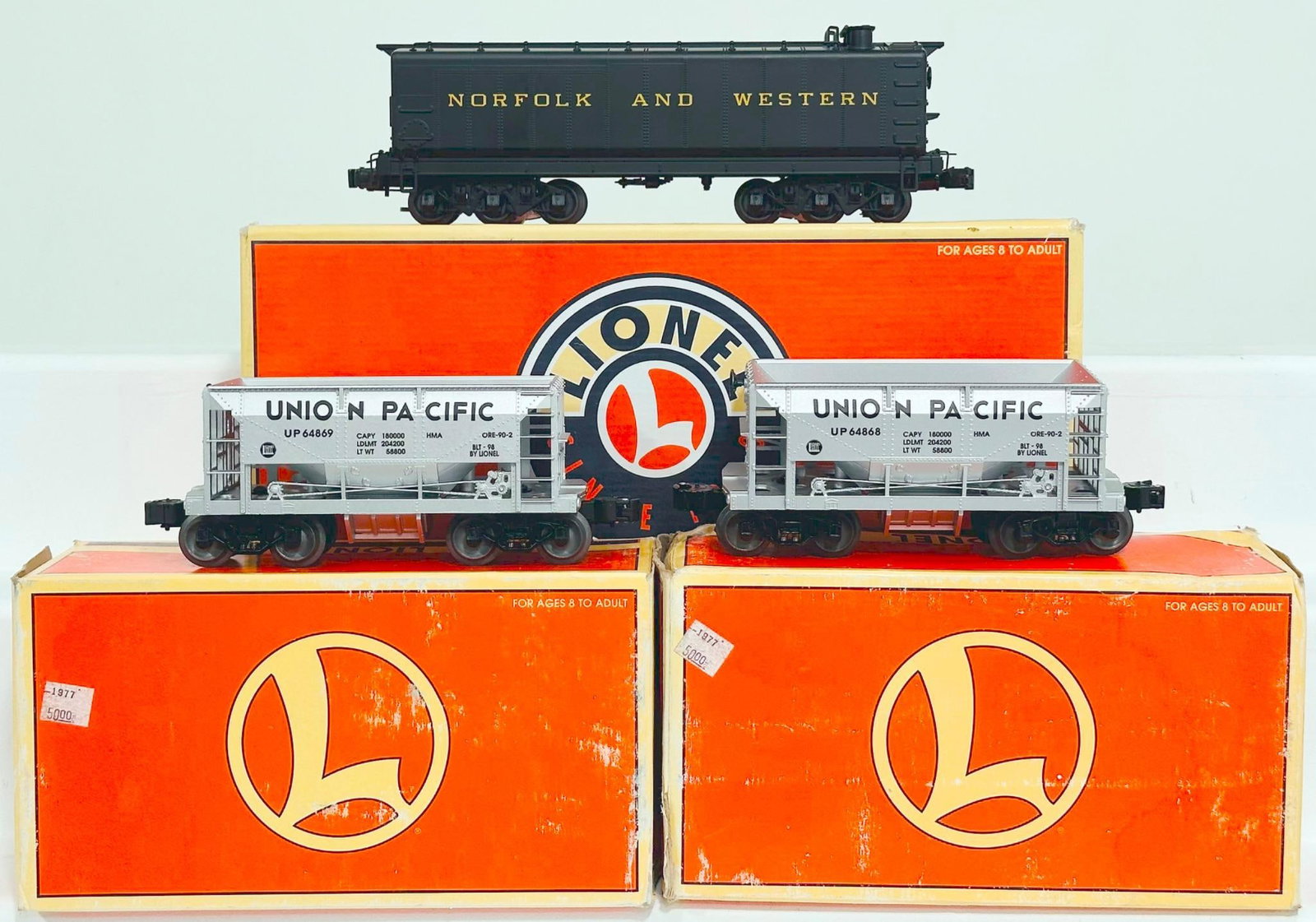 Lionel Modern O Gauge Norfolk and Western Auxiliary Tender & Union Pacific Diecast Metal Ore Car X2: Lionel Modern O Gauge Norfolk and Western Auxiliary Tender and Union Pacific Diecast Metal Ore Car X2, each in C8 or better and each with its original box, and some original boxes show moderate to hea