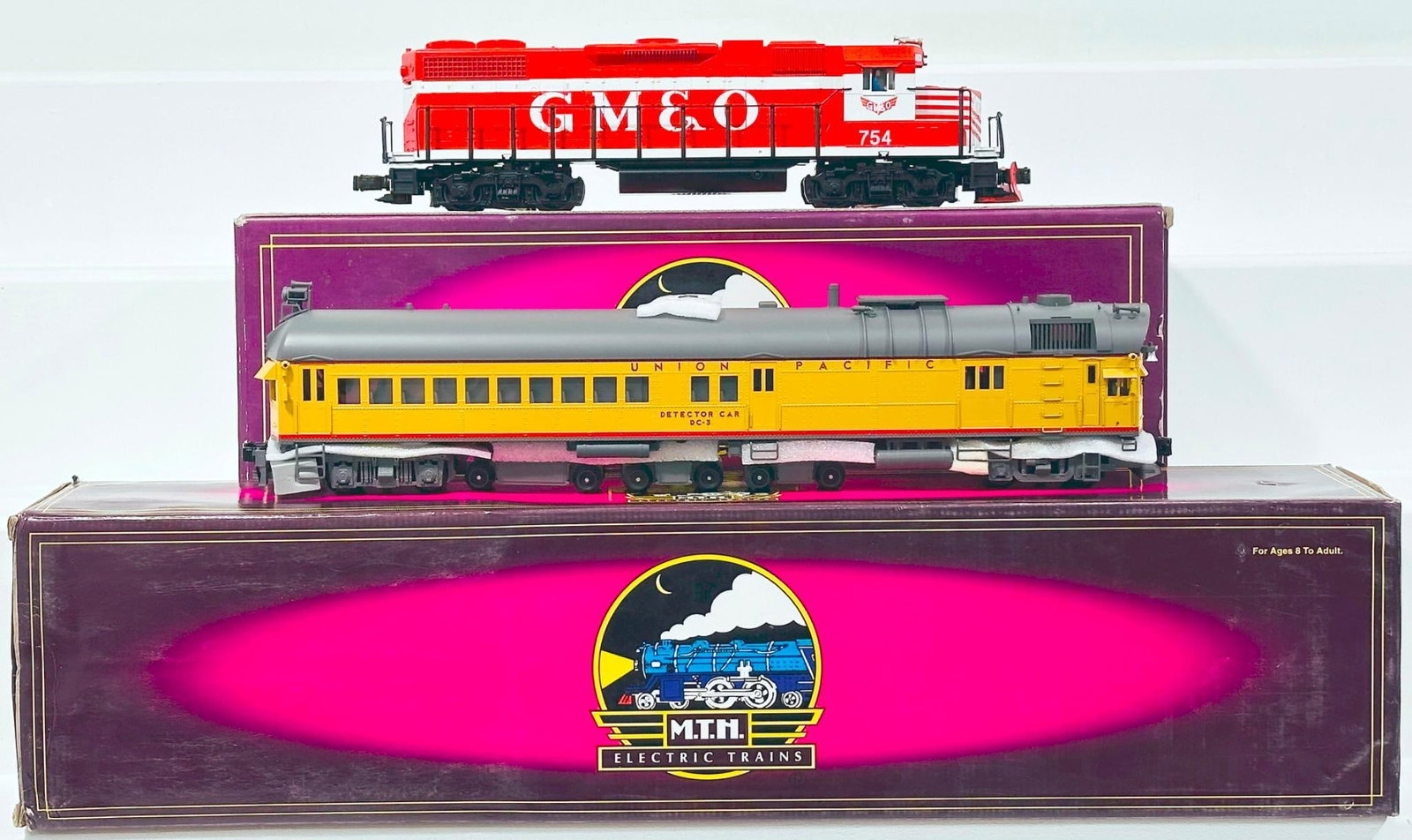 MTH Modern O Gauge EMD GM & O GP 38-2 Diesel Switcher and DC-3 Union Pacific Rail Inspection Car: MTH Modern O Gauge EMD GM & O GP 38-2 Diesel Switcher and DC-3 Union Pacific Rail Inspection Car, with the GP 38 - 2 having PS - 1.0 and the Union Pacific Rail Inspection Car having PS - 2.0, each in 