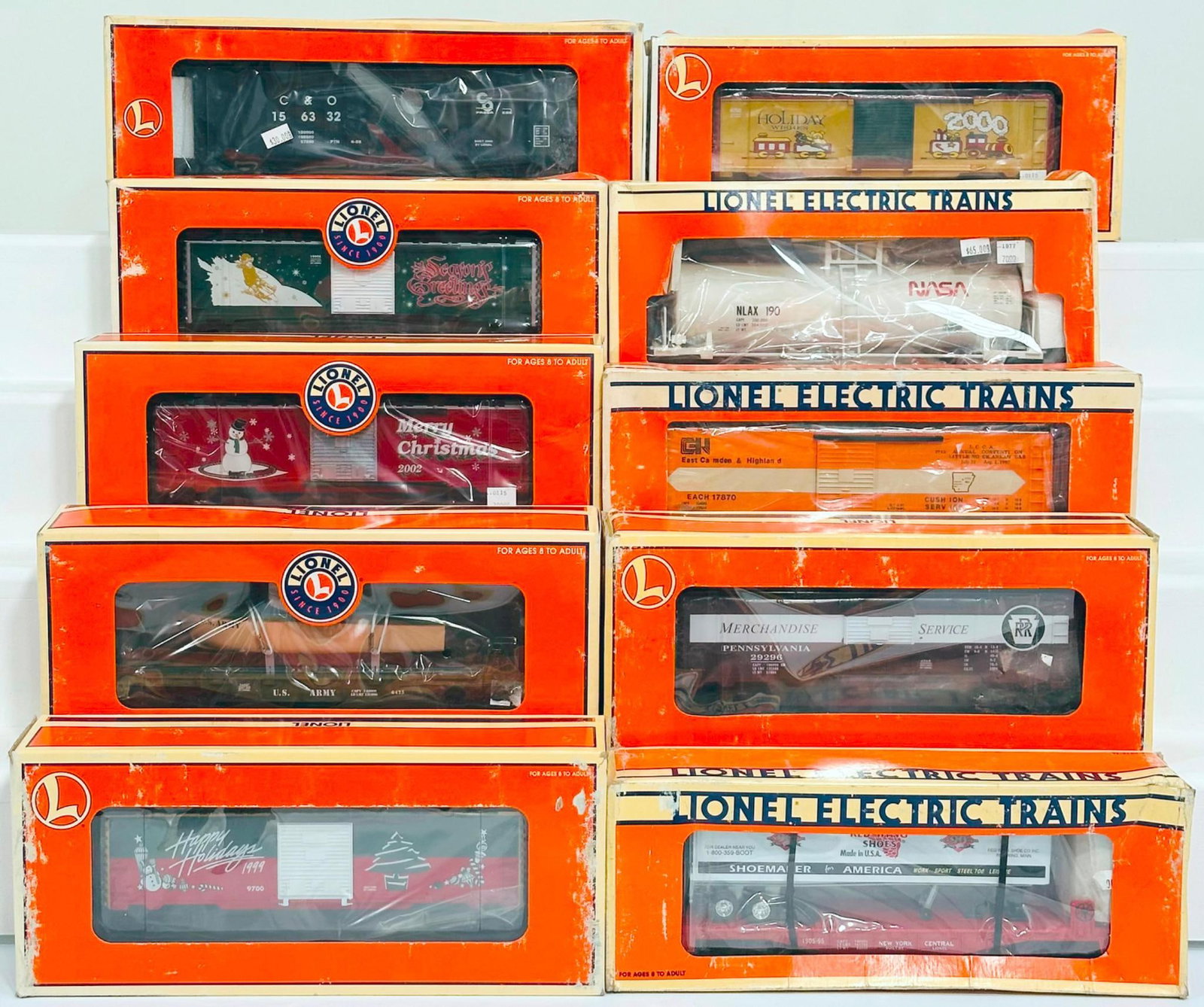 Lionel Modern O Gauge Ten (10) Assorted Freight Cars Boxed: Lionel Modern O Gauge Ten (10) Assorted Freight Cars Boxed, including 1987 LCCA Convention Car, Red Wing Shoes Flat Car with Trailer, U.S. Army Flat Car with boat, 1992 LCCA Convention Car, Box Car Ch