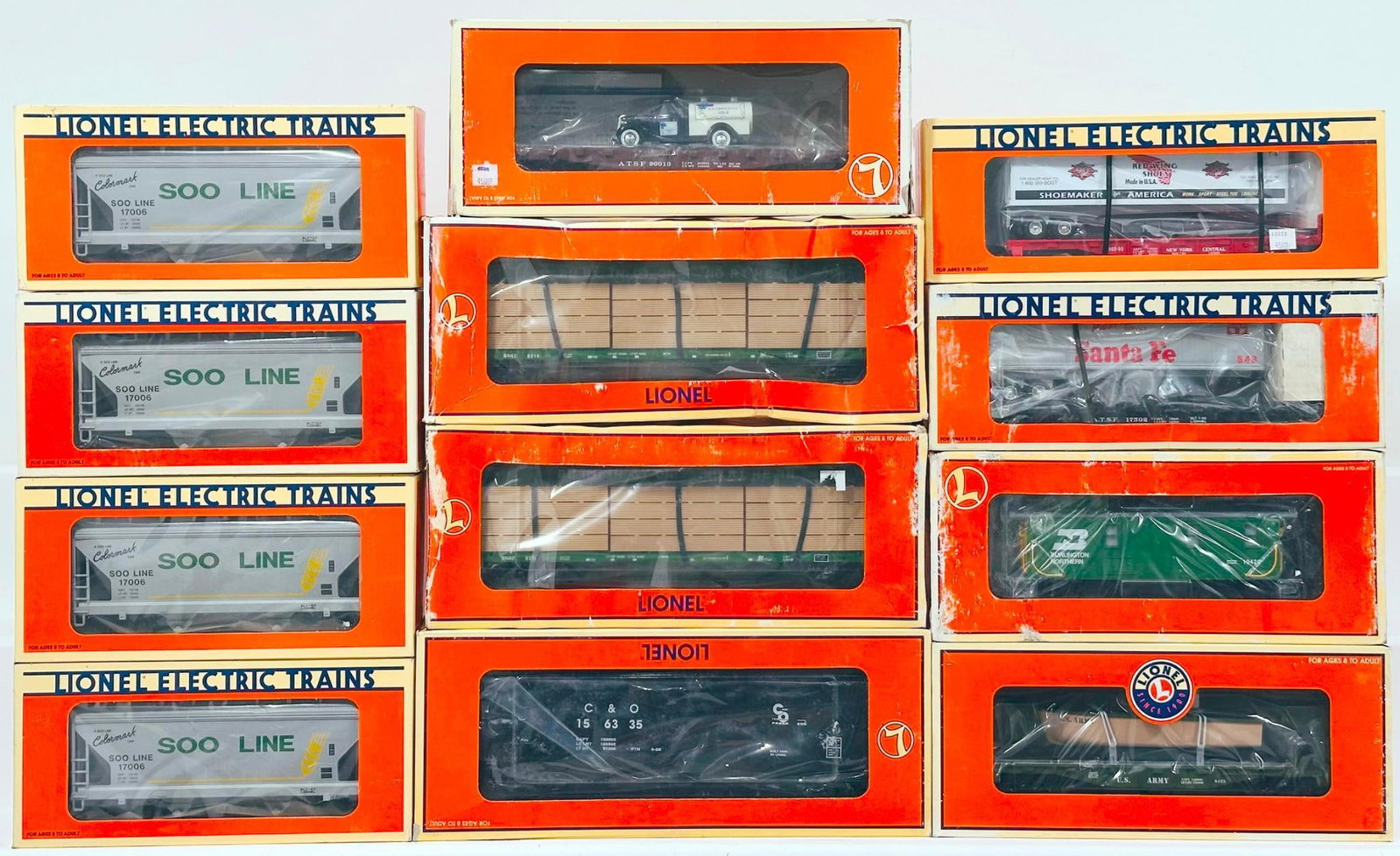 Lionel Modern O Gauge Twelve (12) Assorted Freight Cars Boxed: Lionel Modern O Gauge Twelve (12) Assorted Freight Cars Boxed, including I&D Steel Side CBS - BN, I&D C&O Hopper, FC 1 - Beam Burlington Northern, Red Wing Shoes Flat Car with Trailer, Soo Line 2 Bay 