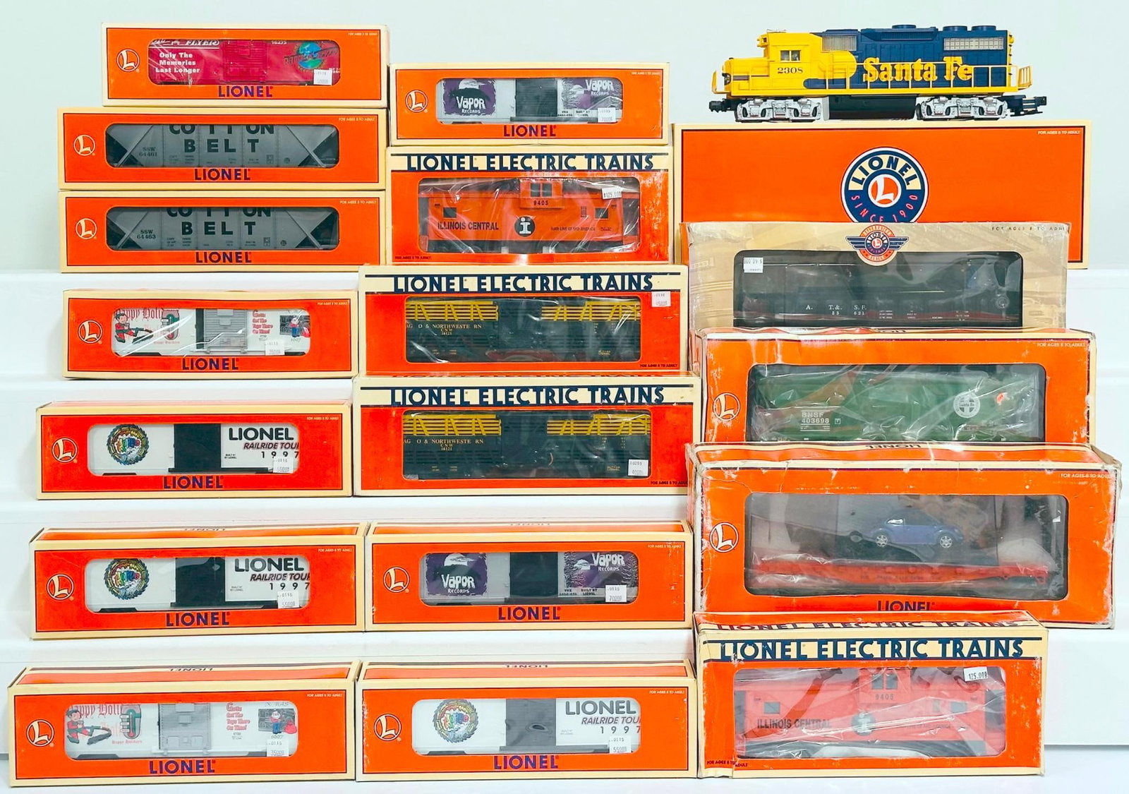 Lionel Modern O Gauge JC Penney Santa Fe GP-38 Switcher/ Seventeen (17) Assorted Freight Cars Boxed: Lionel Modern O Gauge JC Penney Santa Fe GP-38 Switcher and Seventeen (17) Assorted Freight Cars Boxed, including BNSF ACF 3 Bay Covered Hopper, FC with Volkswagen Beetle, Operating Barrel Ramp Car, J
