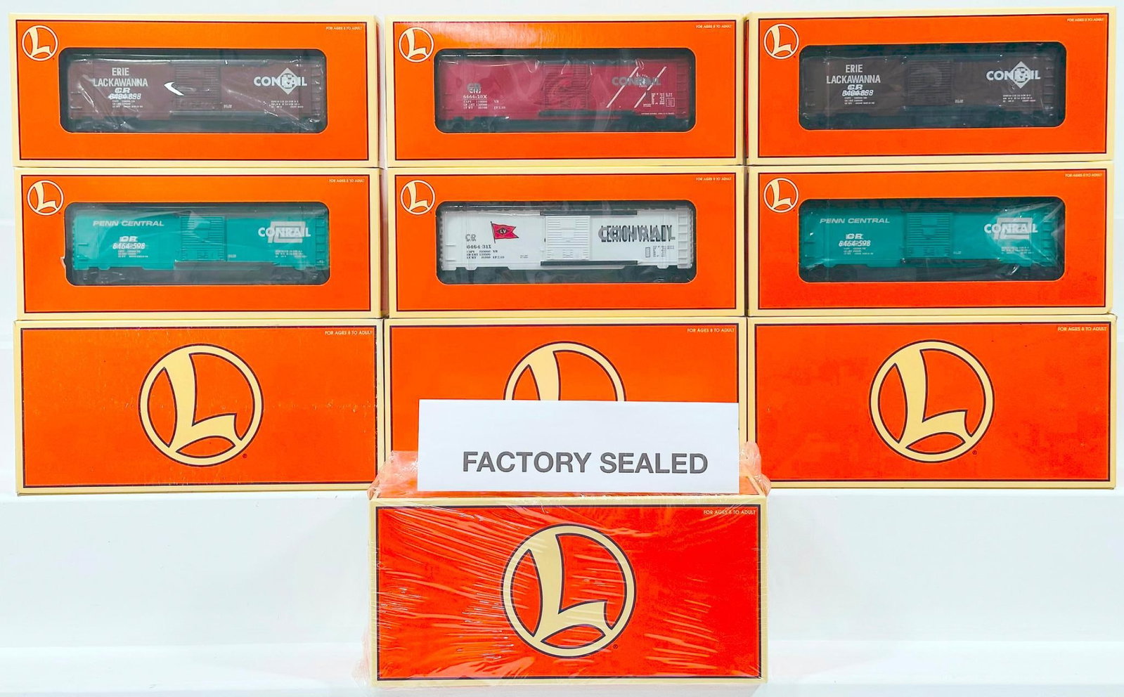 Lionel Modern O Gauge 6464 Box Car Two Pack Overstamped Boxed X4: Lionel Modern O Gauge 6464 Box Car Two Pack Overstamped Boxed X4, each in C9 or better and each with its original box. This Lot also includes a total of eight (8) freight cars.