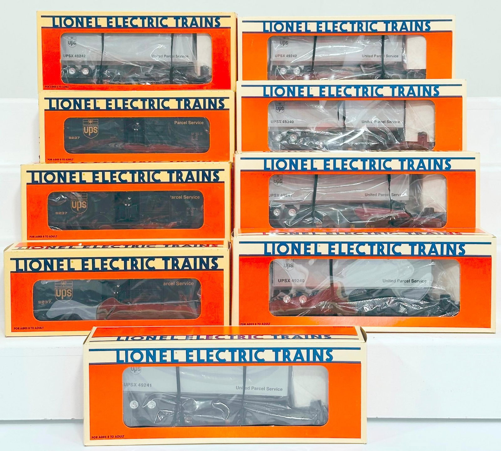 Lionel Modern O Gauge Nine (9) Assorted United Parcel Service Freight Cars Boxed: Lionel Modern O Gauge Nine (9) Assorted United Parcel Service Freight Cars Boxed, including UPS Flat Car with Trailer X6 and UPS Express Box Car X3, each in C9 or better and each with its original box