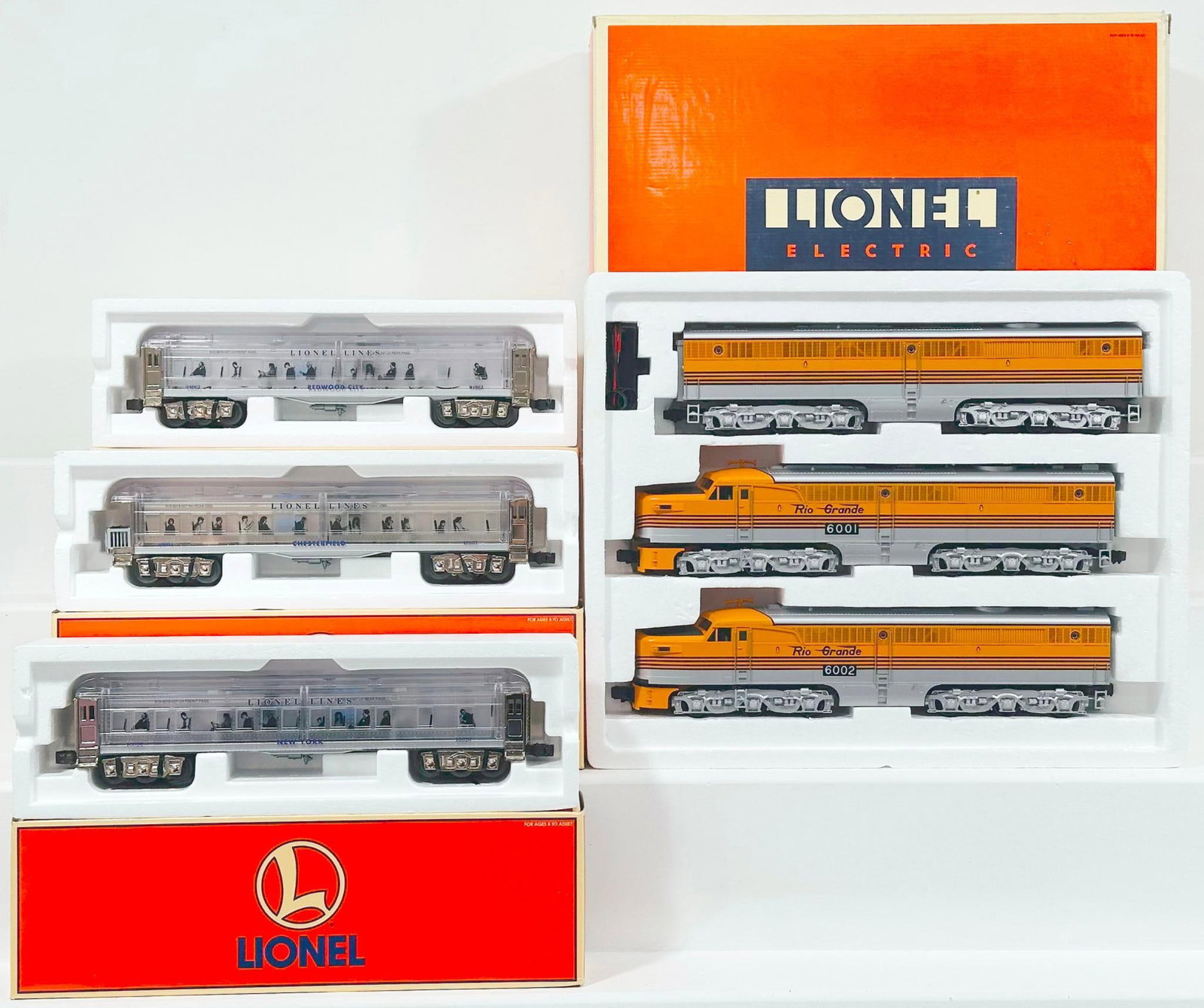 Lionel Modern O Gauge Denver and Rio Grande PA - 1 A-B-A Diesel Units Set/Three (3) Assorted Cars: Lionel Modern O Gauge Denver and Rio Grande PA - 1 A - B - A Diesel Units Set and Three (3) Assorted Clear Madison Passenger Cars Boxed, each in C8 to C9 and each with its original box.