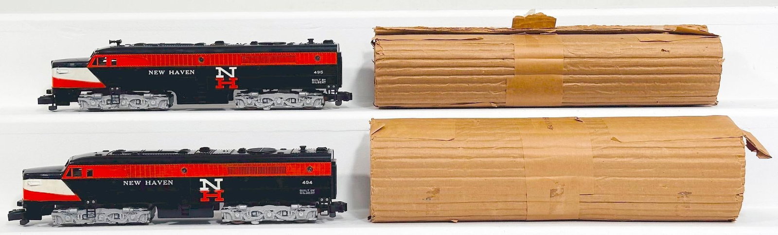 American Flyer Postwar S Gauge 494 and 495 New Haven Alco PAs: American Flyer Postwar S Gauge 494 and 495 New Haven Alco PAs, each in C7 and each with its original wrap. The diesel horn on the 494 is missing.