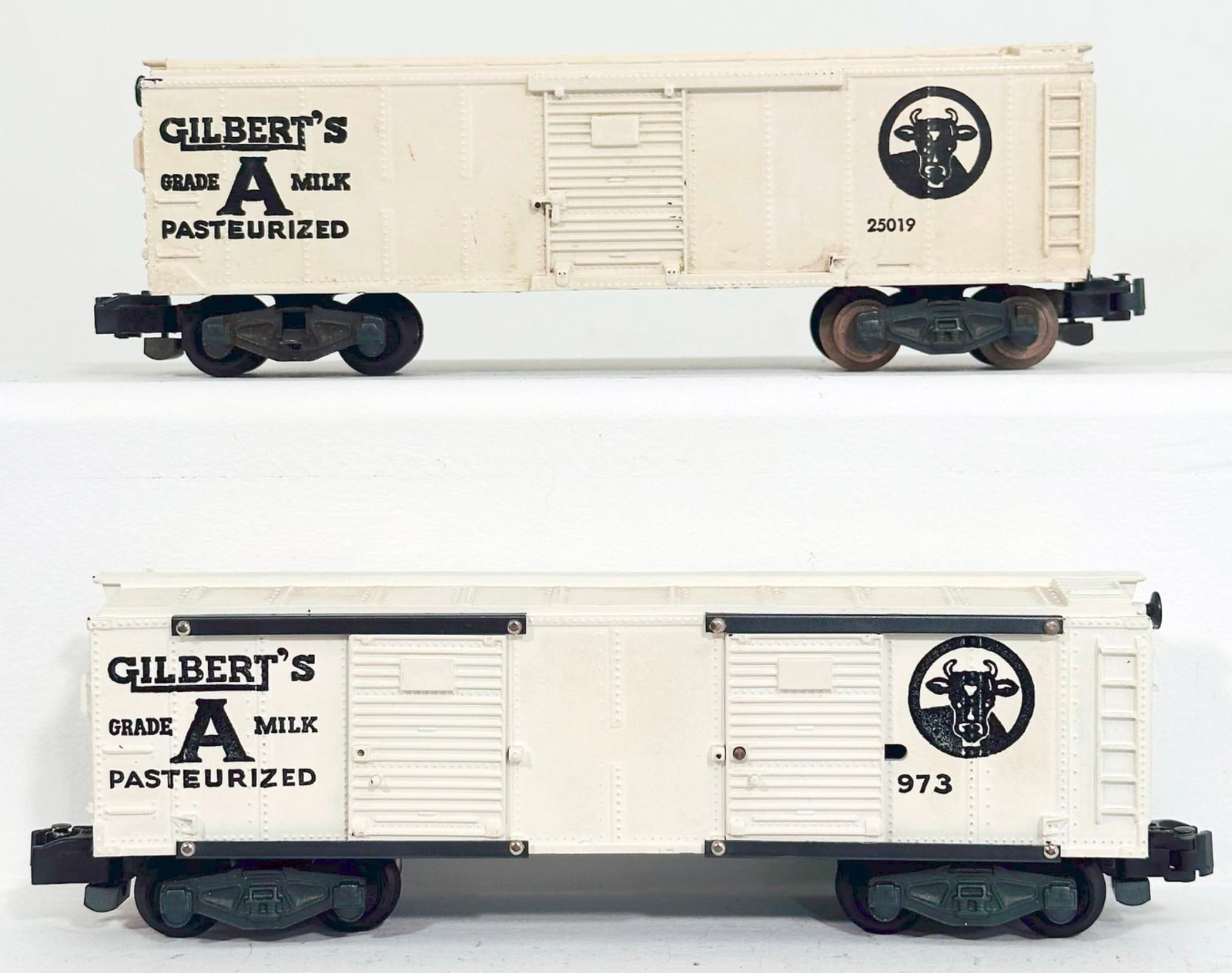 American Flyer Postwar S Gauge 973 Gilbert's Milk Car and 25019 Gilbert's Milk Car: American Flyer Postwar S Gauge 973 Gilbert's Milk Car and 25019 Gilbert's Milk Car, with the 973 in C7 and the 25019 in C7 minus.