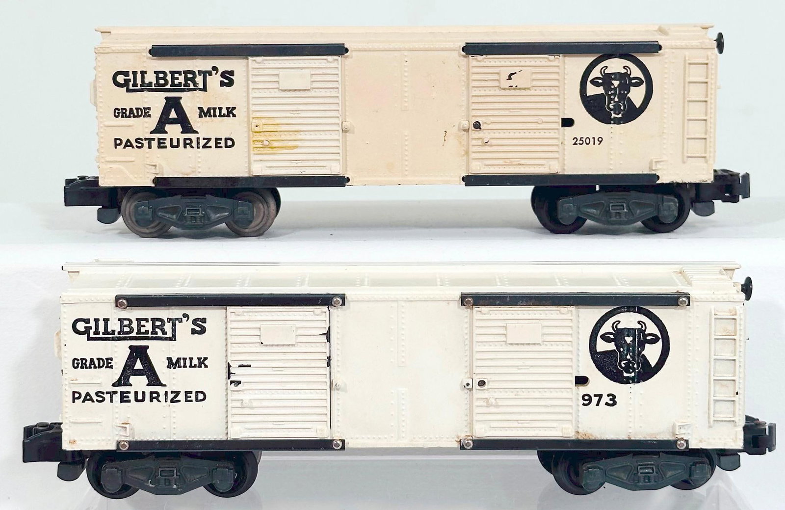 American Flyer Postwar S Gauge 973 Gilbert's Milk Car and 25019 Gilbert's Milk Car: American Flyer Postwar S Gauge 973 Gilbert's Milk Car and 25019 Gilbert's Milk Car, with the 973 in C7 and the 25019 in C7 minus because of the discoloration on one of the doors.