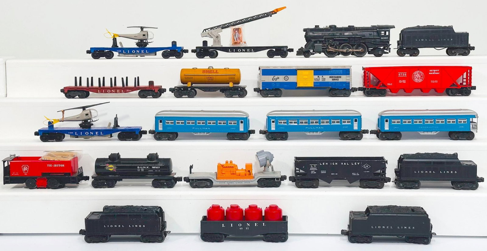 Lionel Postwar O Gauge Assorted Freight Cars and Passenger Cars and 2025 Locomotive and Tender: Lionel Postwar O Gauge Assorted Freight Cars and Passenger Cars, in C6 to C7. Includes 2440 - 2440 and 2441 Passenger Cars that are repainted, and includes 2025 Locomotive and Tender. This is a Genera