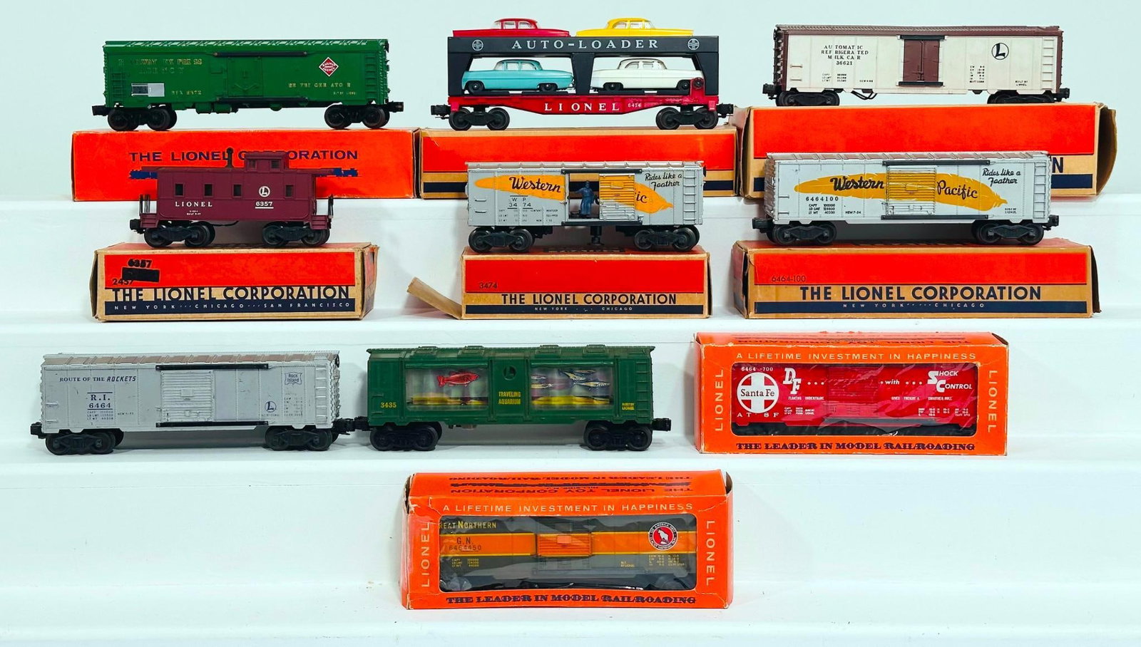 Lionel Postwar O Gauge Assorted Freight Cars and 3662 Operating Milk Car: Lionel Postwar O Gauge Assorted Freight Cars and 3662 Operating Milk Car, each in C7 or better. This Lot includes 6464-450, 6464-100, 6357 Caboose, 6414 Automobile Car, 6572 REA Car, 6464-700 and 3474