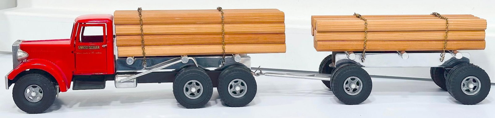 Smith - Miller Postwar Truck and Trailer with Lumber Load: Smith - Miller Postwar Truck and Trailer with Lumber Load, in C7 minus because the front bumper is broken but the pieces present.