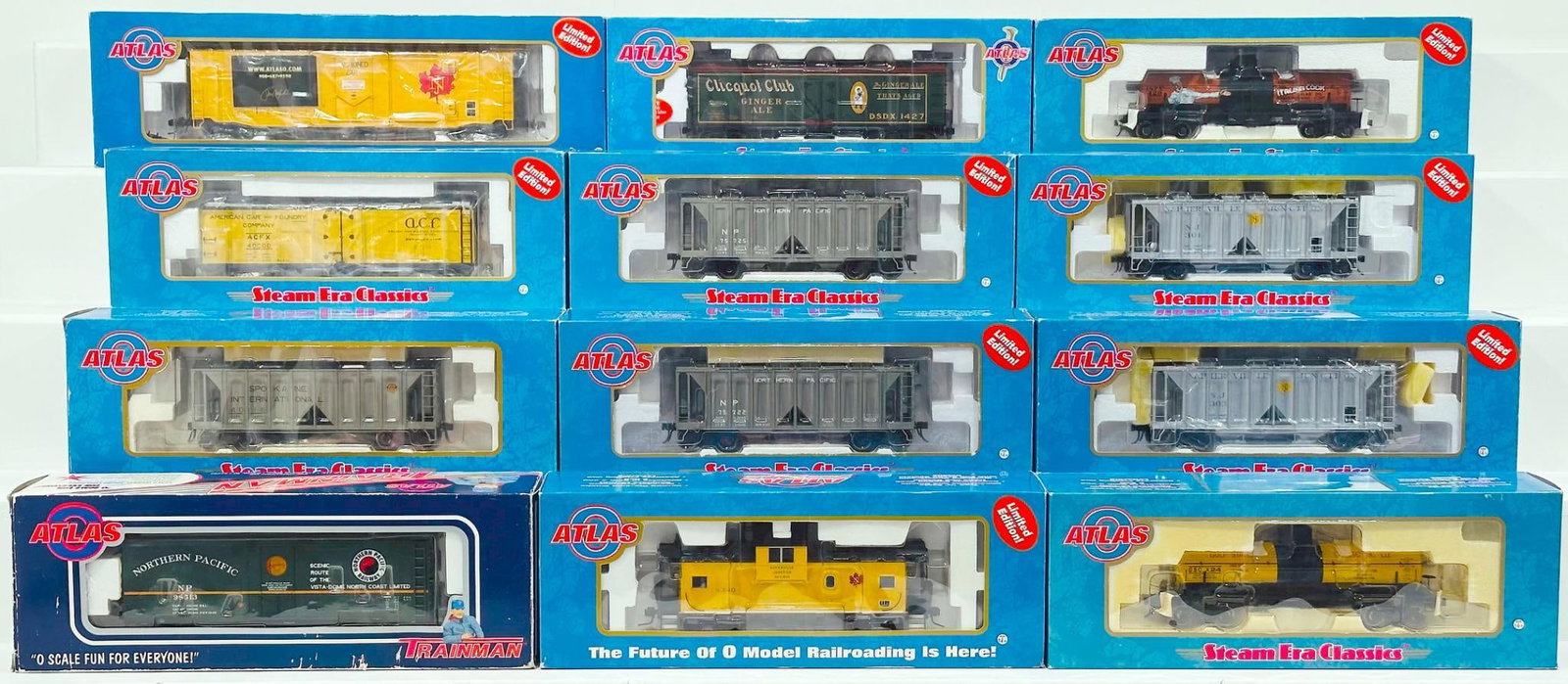 Atlas Modern O Gauge Twelve (12) Assorted Freight Cars Boxed: Atlas Modern O Gauge Twelve (12) Assorted Freight Cars Boxed, including Northern Pacific Hopper Car, Northern Pacific 40 foot plug Door Box Car, Napierville Junction Covered Hopper Car, Hallan Kirk