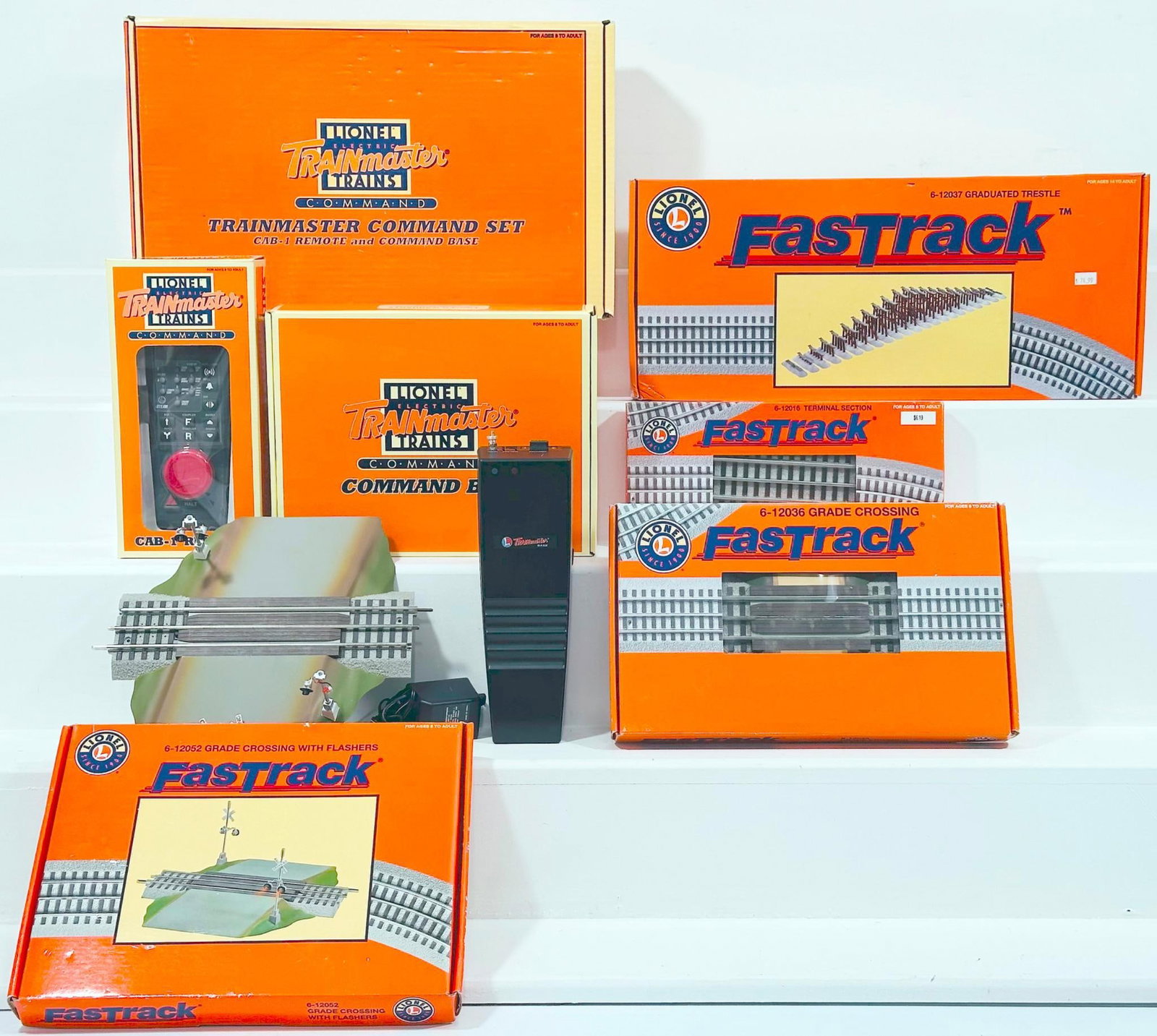 Lionel Modern O Gauge Trainmaster Command Set/Fastrack Grade Crossing with Flashers/ Fastrack: Lionel Modern O Gauge Trainmaster Command Set/Fastrack Grade Crossing with Flashers/ Fastrack Graduated Trestle/ Fastrack Grade Crossing and Terminal Section, each in C9 and each with its original box