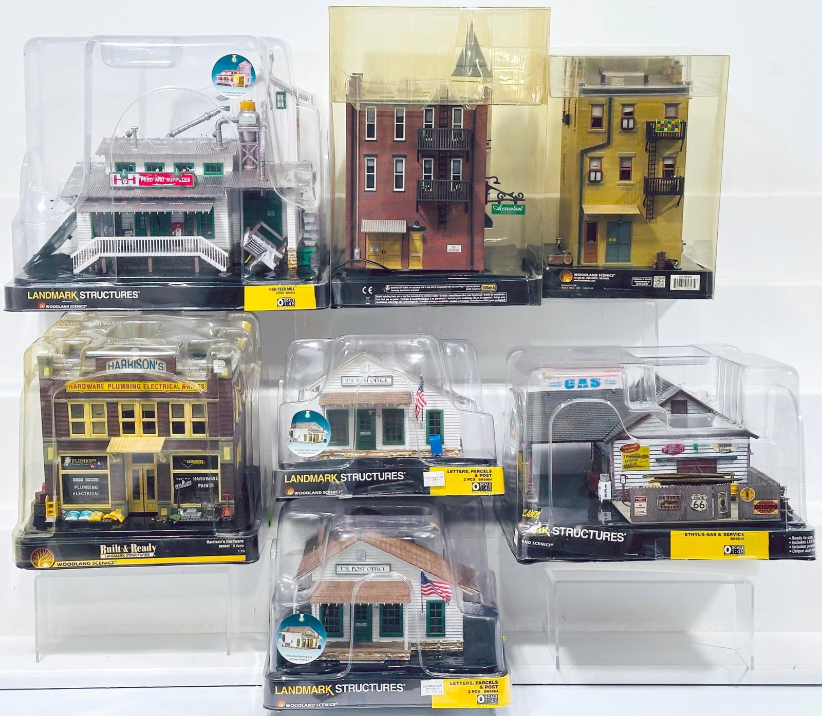 Woodland Scenics Modern O Gauge Seven (7) Assorted Buildings with plastic packaging: Woodland Scenics Modern O Gauge Seven (7) Assorted Buildings with plastic packaging, including H & H Feed Mill, Davenport Department Store, Letters, Parcels & Post X2, Harrison's Hardware, J. W. Cobbl