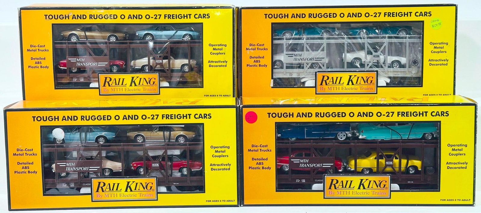 MTH Modern Rail King O Gauge Auto Transport Carrier with Ertl Loads Boxed X4: MTH Modern Rail King O Gauge Auto Transport Carrier with Ertl Loads Boxed X4, each in C9 and each with its original box.