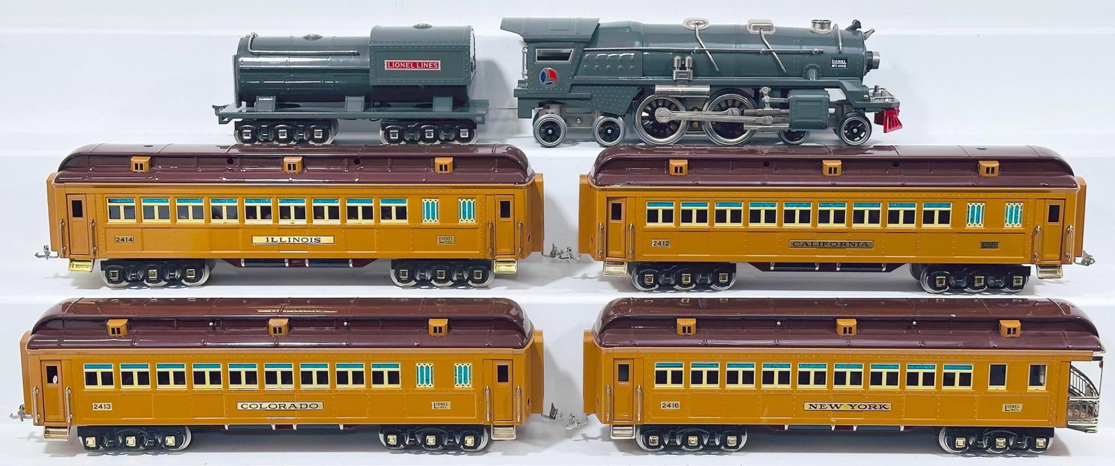 Lionel Modern Classics Standard Gauge Gunmetal 400E Locomotive and Tender and Four (4) Assorted: Lionel Modern Classics Standard Gauge Gunmetal 400E Locomotive and Tender and Four (4) Assorted Two-Tone Brown State Cars, with the 400E Locomotive and Tender, each in C8 minus, and the 2414, 2412 and