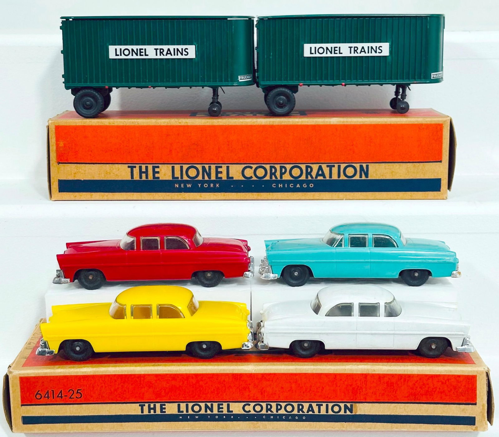 Lionel Postwar O Gauge 460 - 150 Two Trailer Separate Sale and 6414 - 25 Four Automobiles Separate: Lionel Postwar O Gauge 460 - 150 Two Trailer Separate Sale and 6414 - 25 Four Automobiles Separate Sale Boxed, each in C7 plus to C8 minus or better and each with its original box.