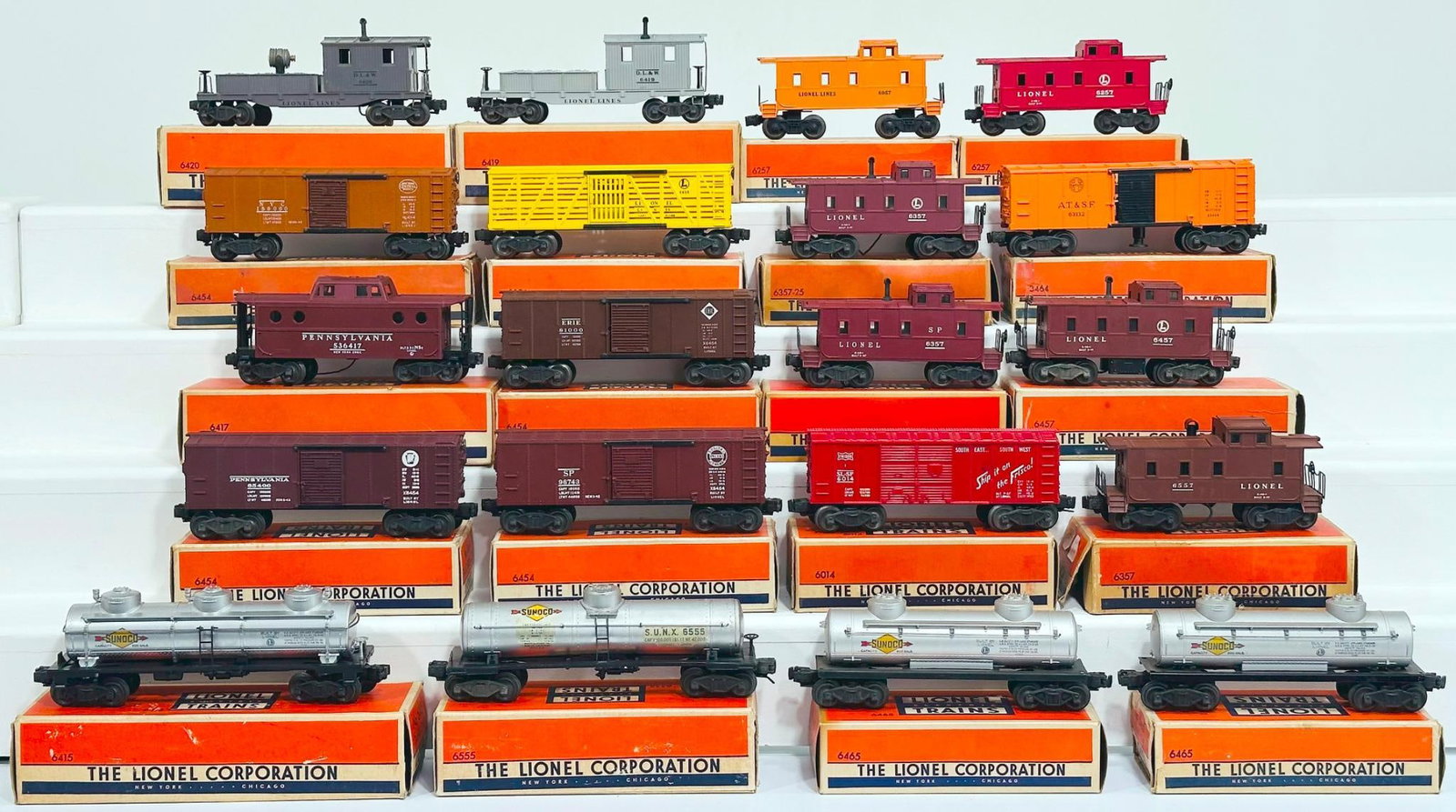 Lionel Postwar O Gauge Twenty (20) Assorted Freight Cars: Lionel Postwar O Gauge Twenty (20) Assorted Freight Cars, including 6465 Tank Car, 6419 Wrecking Car, 6420 Searchlight Car, 6454 PRR Box Car, 6014 Box Car, 6357 Caboose, 6656 Stock Car, 6457 Caboose, 