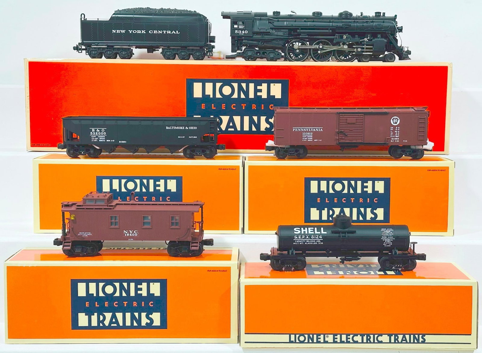 Lionel Modern O Gauge New York Central 700E 4 - 6 - 4 Hudson Locomotive and Tender and Four (4): Lionel Modern O Gauge New York Central 700E 4 - 6 - 4 Hudson Locomotive and Tender and Four (4) Assorted Diecast Freight Cars Boxed, including 700E Locomotive and Tender, each in C9 and with its origi