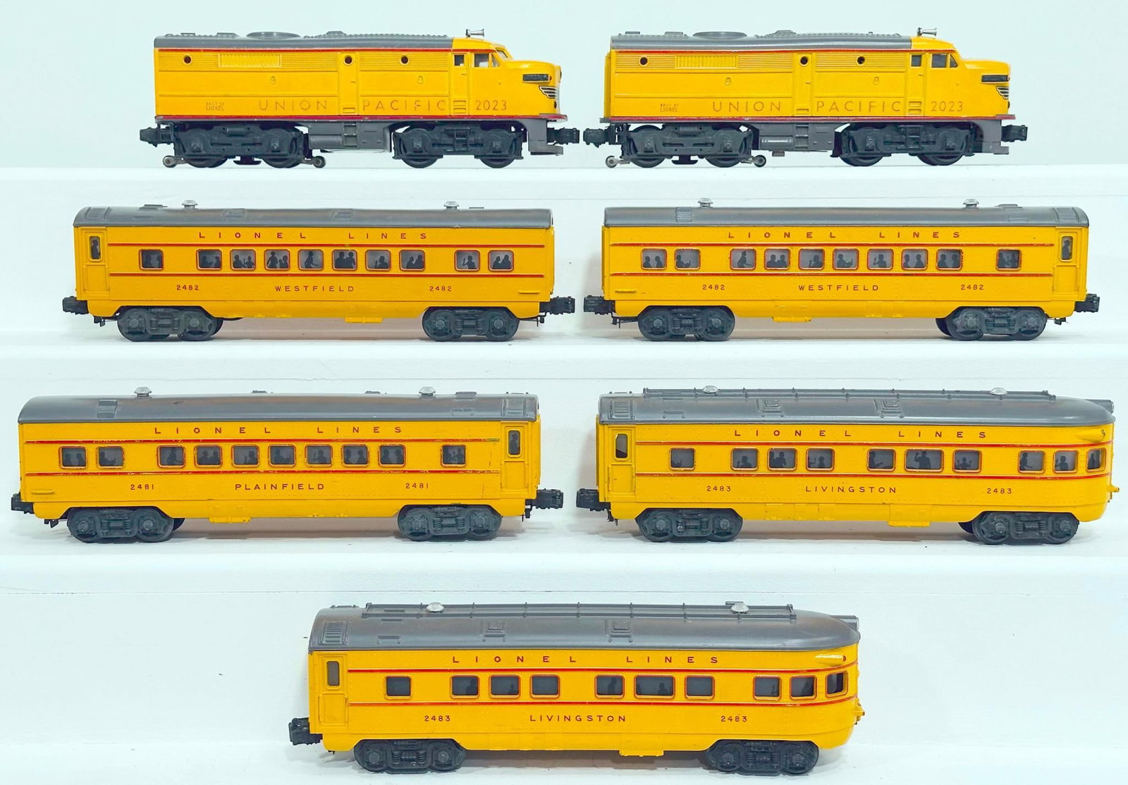 Lionel Postwar O Gauge 2023 Union Pacific Alco A - A Diesel Units and Six (6) Assorted yellow and: Lionel Postwar O Gauge 2023 Union Pacific Alco A - A Diesel Units and Six (6) Assorted yellow and gray roof Passenger Cars, with the 2023 A - A, each in C7 minus, and including 3482 in C7, 2483 in C7,