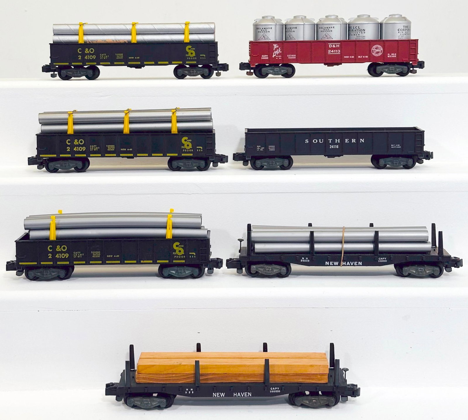 American Flyer Postwar S Gauge Seven (7) Assorted Freight Cars: American Flyer Postwar S Gauge Seven (7) Assorted Freight Cars, including 24109 with pipe load in C7 - missing two stakes, 24109 with pipe load in C7, 24109 with pipe load in C7 plus, 24113 in C7 with