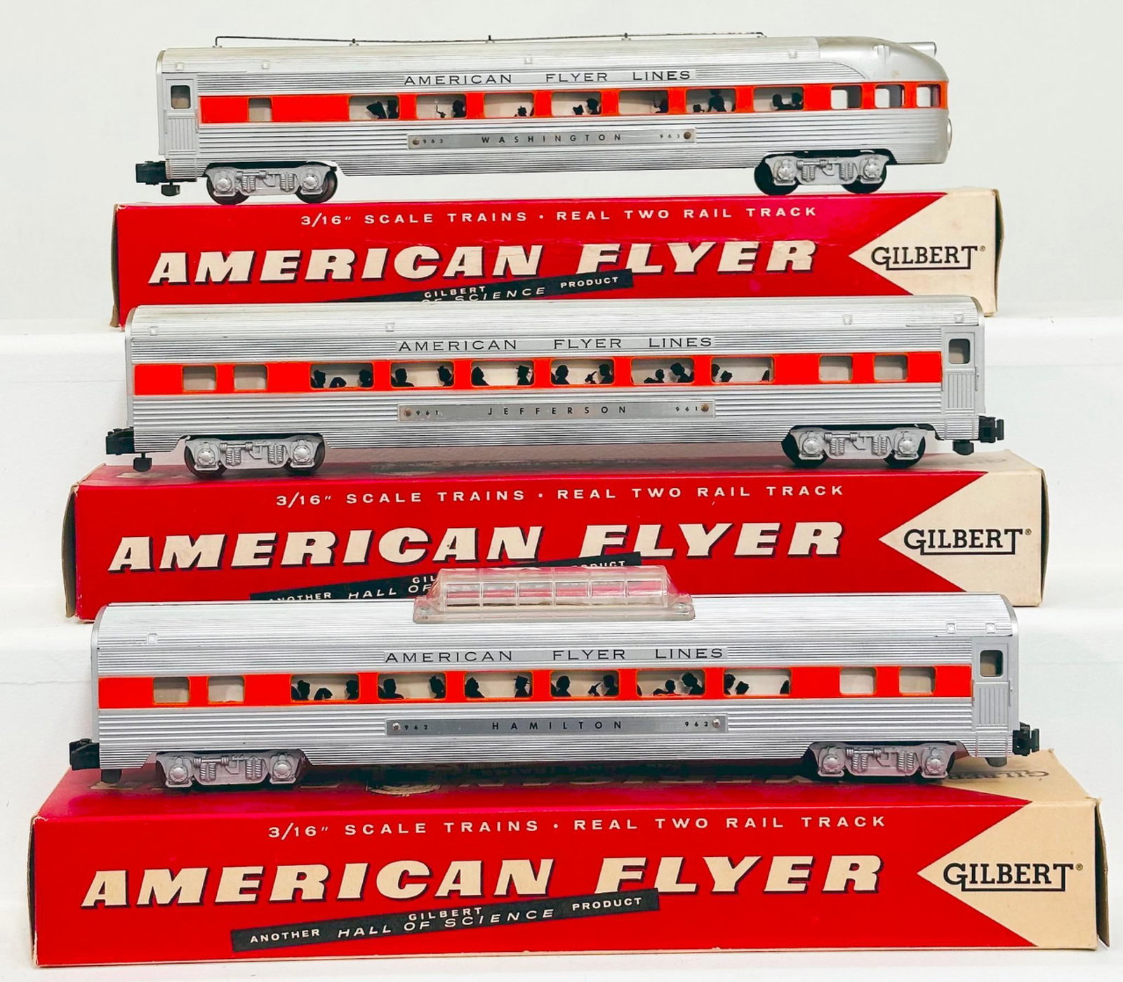 American Flyer Postwar S Gauge 962 - 961 - 963 Aluminum Passenger Cars with orange stripe through: American Flyer Postwar S Gauge 962 - 961 - 963 Aluminum Passenger Cars with orange stripe through windows, each in C7 and with original boxes numbered 24835, 24795 and 962.