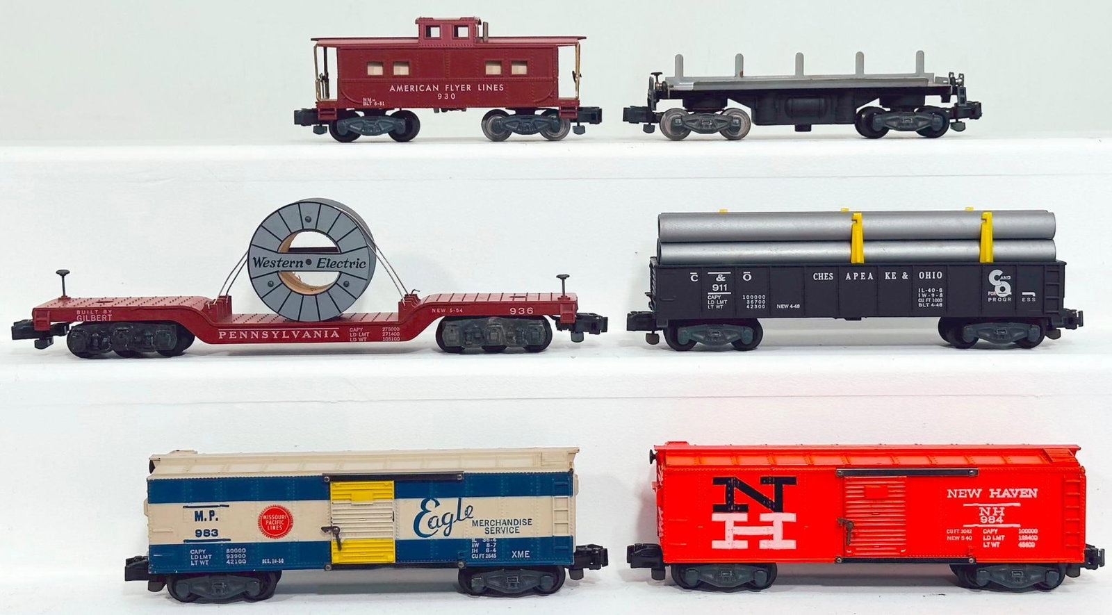 American Flyer Postwar S Gauge Six (6) Assorted Freight Cars: American Flyer Postwar S Gauge Six (6) Assorted Freight Cars, including 930 in C7 plus, 983 in C7, 936 in C7 plus, 911 with pipe load in C7 plus, 984 in C7 plus and 914 without load in C7.