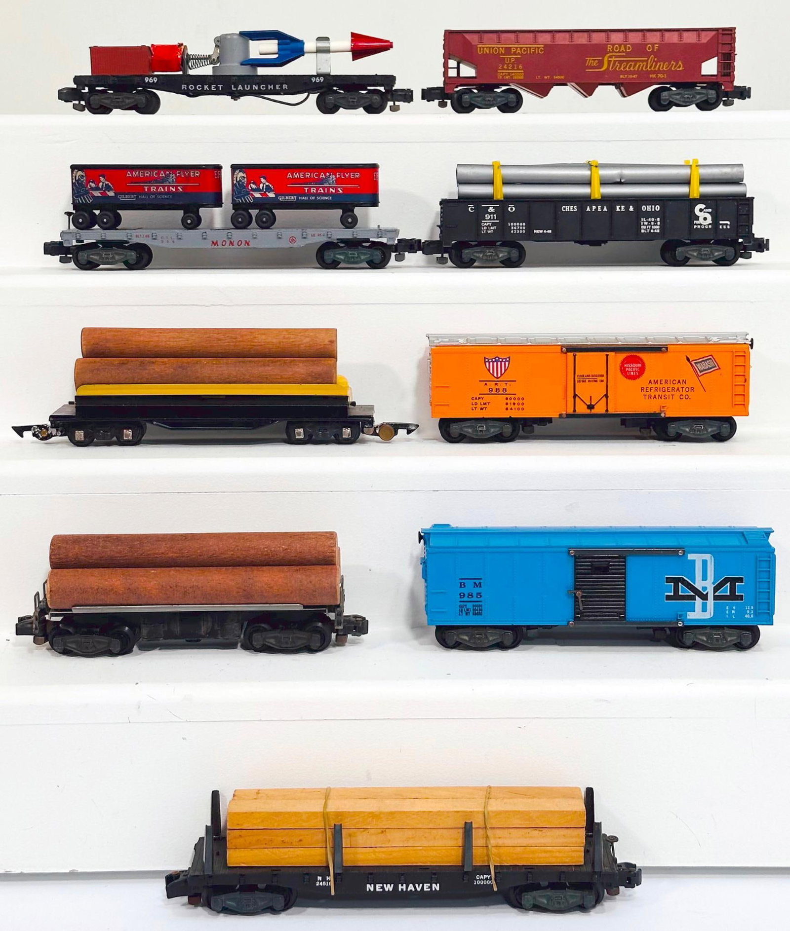 American Flyer Postwar S Gauge Nine (9) Assorted Freight Cars: American Flyer Postwar S Gauge Nine (9) Assorted Freight Cars, including 24216 in C7 plus, 911 with pipe load in C7, 985 in C7 with some small rust on door guides, 988 in C7, 24516 with lumber load in
