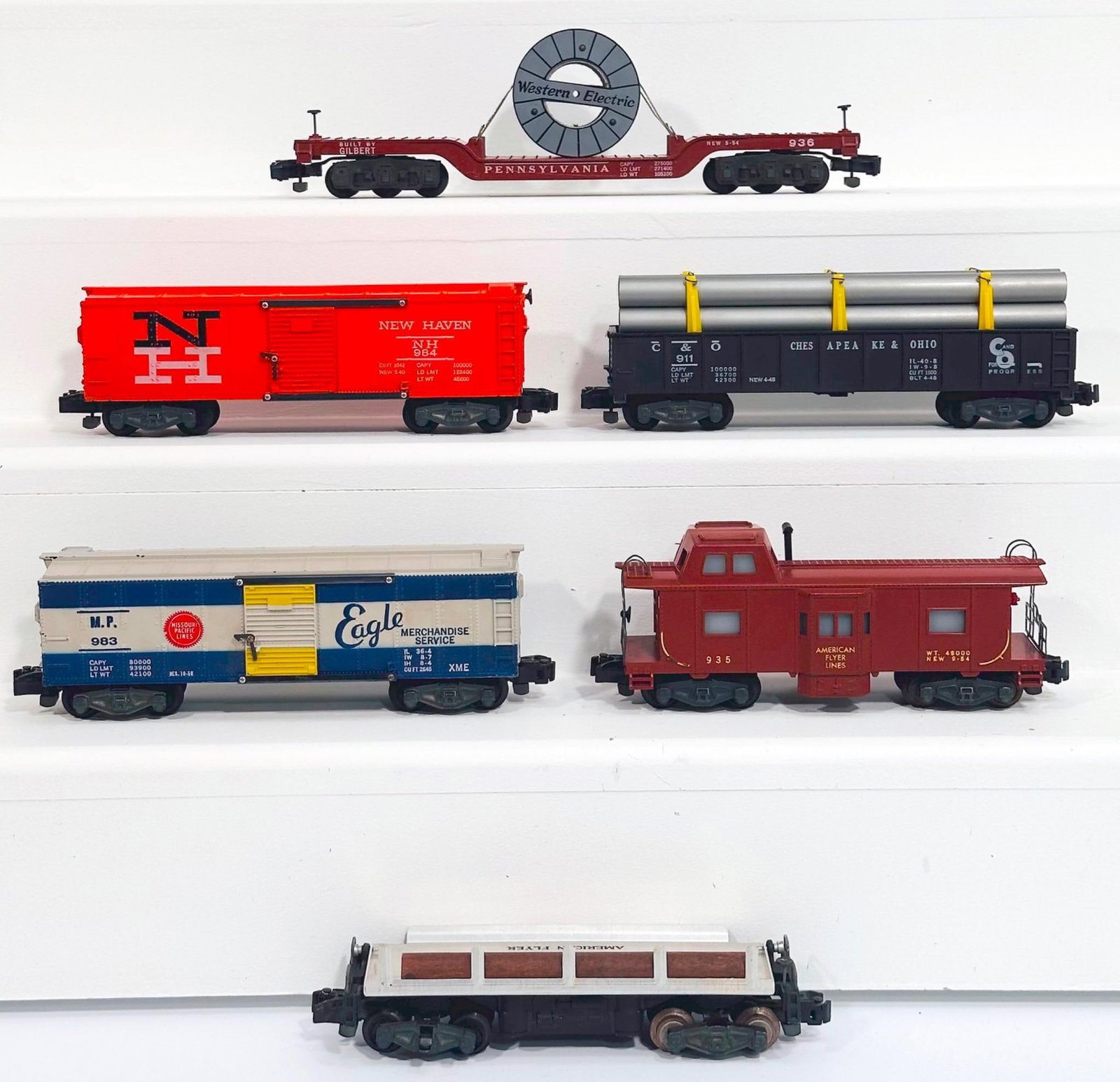 American Flyer Postwar S Gauge Six (6) Assorted Freight Cars: American Flyer Postwar S Gauge Six (6) Assorted Freight Cars, including 983 in C7 plus, 914 with log load in C7 plus, 935 in C7 plus, 984 in C7 plus, 911 with silver pipe load in C7 plus and 936 in C7